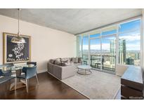 Modern living room with city views, comfortable seating, and hardwood floors at 891 14Th St # 3807, Denver, CO 80202