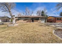 Charming single-story home featuring a brick facade and well-maintained front yard and driveway at 9180 Raleigh St, Westminster, CO 80031