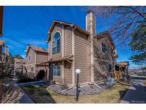 Charming exterior view of a brown two story home with a manicured lawn and blue sky at 1832 S Quintero Way, Aurora, CO 80017