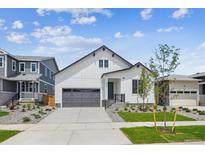 Charming two-story home featuring a modern exterior, well-kept lawn, and a two-car garage at 1121 Joseph Pl, Erie, CO 80026