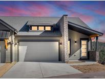 Modern mountain home exterior with attached garage and stone accents at 3897 Piney Grove St, Evergreen, CO 80439