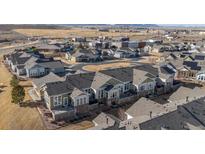 Beautiful aerial view of a new home community showcasing modern homes and planned community design in a mountain adjacent setting at 14434 W 88Th Dr # B, Arvada, CO 80005