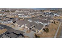 Stunning aerial view of townhomes featuring neat landscaping and convenient parking areas in a well maintained neighborhood at 14434 W 88Th Dr # B, Arvada, CO 80005