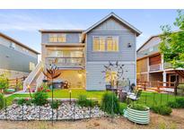Landscaped backyard features a hot tub, seating area, and manicured lawn at 4738 Colorado River Dr, Firestone, CO 80504