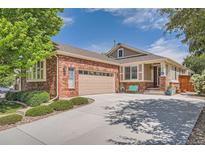 Charming brick home featuring a two-car garage and a well-manicured front yard at 20058 E Dartmouth Dr, Aurora, CO 80013