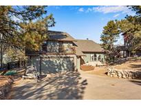 Two-story house with a large driveway, attached garage, and balcony at 9593 Coronado Ct, Parker, CO 80134