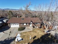 Ranch-style brick home with attached garage on a sunny lot with mountain views at 12771 W 6Th Pl, Lakewood, CO 80401