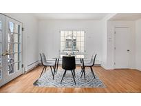 Bright dining area features hardwood floors, a window and a modern table with chairs at 960 N Sherman St # 2G, Denver, CO 80203