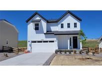 Charming two-story home with white siding, black trim, and a spacious two-car garage at 39743 Penn Rd, Elizabeth, CO 80107