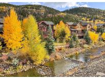 Scenic home exterior featuring a mountain stream and vibrant autumn foliage at 186 Rachel Ln, Breckenridge, CO 80424