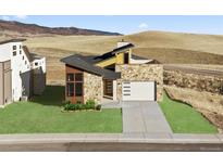 Contemporary stone home featuring a two-car garage and beautifully landscaped front yard, situated on a hill at 5741 Doc Bar Circle, Larkspur, CO 80118