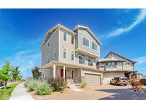Beautiful two-story home with a brick driveway, covered porch, and manicured landscaping at 16362 E 111Th Dr, Commerce City, CO 80022