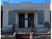 Charming duplex with brick facade, individual entrances, and wrought iron railings at 3325 Navajo St, Denver, CO 80211