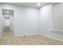 Bright living room featuring wood floors and a window with blinds, offering a clean and inviting space at 3325 Navajo St, Denver, CO 80211