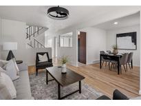 Inviting living room with modern decor, wood floors, and plenty of natural light at 9338 W Utah Pl, Lakewood, CO 80232