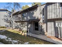 Charming townhome featuring a balcony, covered entry, and vertical wood siding at 2308 Hearth Dr # 28, Evergreen, CO 80439