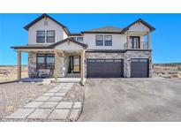 Beautiful two-story home featuring stone accents, a three-car garage, and a covered porch with rocking chairs at 8700 Lost Lake Dr, Franktown, CO 80116