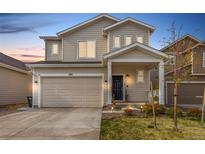 Charming two-story home with a well-maintained lawn and inviting front porch, featuring a two car garage at 509 High Point Dr, Longmont, CO 80504