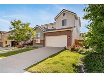 Two-story home with a two-car garage, driveway, landscaped yard and beautiful curb appeal at 14035 Touchstone St, Parker, CO 80134