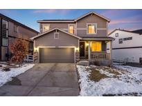 Two-story house with gray siding, attached garage, and front porch at 2633 Garganey Dr, Castle Rock, CO 80104