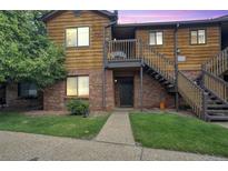 Inviting condominium with a well-maintained lawn and classic wood and brick facade at 2237 S Buckley Rd # 101, Aurora, CO 80013