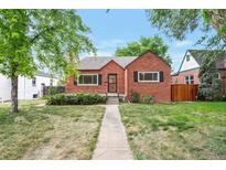 Charming brick home with well-maintained front lawn and inviting walkway at 1335 Locust St, Denver, CO 80220