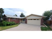Charming brick home with a two-car garage and well-maintained front yard and long driveway at 8947 Rutgers St, Westminster, CO 80031