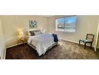 Bright bedroom featuring a large window and neutral tones at 7695 E Quincy Ave # 207, Denver, CO 80237