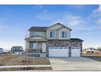 Charming two-story home with a three-car garage, stone accents and covered porch at 4204 Sandstone Dr, Mead, CO 80504