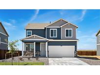 Charming two-story home featuring a two car garage and a well-maintained front yard with beautiful blue siding at 4204 Sandstone Dr, Mead, CO 80504