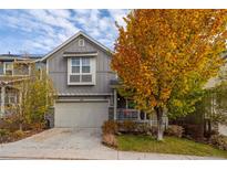 Two-story home with gray siding, attached garage, and autumn landscaping at 1867 W 137Th Ln, Broomfield, CO 80023