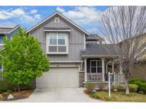 Charming gray two-story home with a well-manicured lawn and inviting front porch at 1867 W 137Th Ln, Broomfield, CO 80023