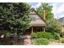 Charming two-story home featuring brick accents and mature landscaping at 4224 N Clay St, Denver, CO 80211