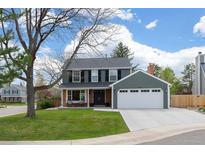Charming two-story home with a well-manicured lawn and classic architectural details at 9391 W Hialeah Pl, Littleton, CO 80123
