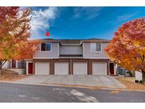 Charming townhouse with brick facade, attached garages, and colorful autumn foliage at 10380 W 55Th Ln # 204, Arvada, CO 80002