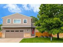 Charming two-story home with a well-maintained lawn, beautiful mature tree, and lovely curb appeal at 12433 Bellaire Dr, Thornton, CO 80241