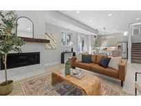 Contemporary living room features a fireplace, wood floors, and modern decor at 1625 King St # 4, Denver, CO 80204