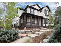 Inviting two-story home with a charming front porch and well-manicured landscaping at 479 Blue Lake Trl, Lafayette, CO 80026