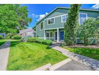 Charming townhome featuring a well-manicured front lawn and inviting front porch at 1229 James Cir # 1, Lafayette, CO 80026