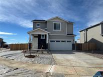 Charming two-story home featuring a two-car garage and appealing exterior at 9353 Yampa Ct, Commerce City, CO 80022