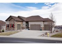 Charming two-story home featuring a three-car garage, stone accents, and a well-maintained yard at 3910 Mighty Oaks St, Castle Rock, CO 80104