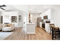 Bright kitchen featuring stainless steel appliances, white cabinets, and a center island with counter seating at 14353 E 1St Dr # 301, Aurora, CO 80011