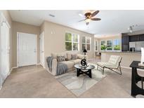 Comfortable living room featuring neutral tones, modern furnishings, and abundant natural light at 9637 E 5Th Ave # 101, Denver, CO 80230