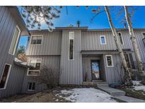 Stylish two-story home featuring sleek gray wood siding and a neatly maintained front yard landscape at 2308 Hearth Dr # 37, Evergreen, CO 80439