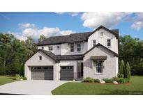 New two-story home boasts a three-car garage, white and brick facade, and well-maintained landscaping at 1696 Green Fern Pt, Castle Rock, CO 80104