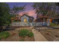 Charming home featuring a white picket fence, lush greenery, and a welcoming walkway at 3042 N Franklin St, Denver, CO 80205