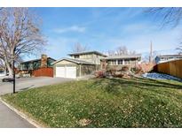 Ranch-style home with attached two-car garage and a spacious yard at 10596 Ura Ln, Northglenn, CO 80234