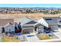 Charming single-Gathering home featuring a well-manicured lawn, a two-car garage, and beautiful mountain views in the background at 55 S Edge Cliff St, Castle Rock, CO 80104