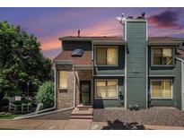 Inviting townhome featuring a blend of brick and siding and colorful evening skies at 8753 W Cornell Ave # 12-1, Denver, CO 80227