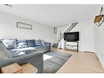 Inviting living room featuring a comfortable couch and staircase at 7973 Chase Circle # 54, Arvada, CO 80003